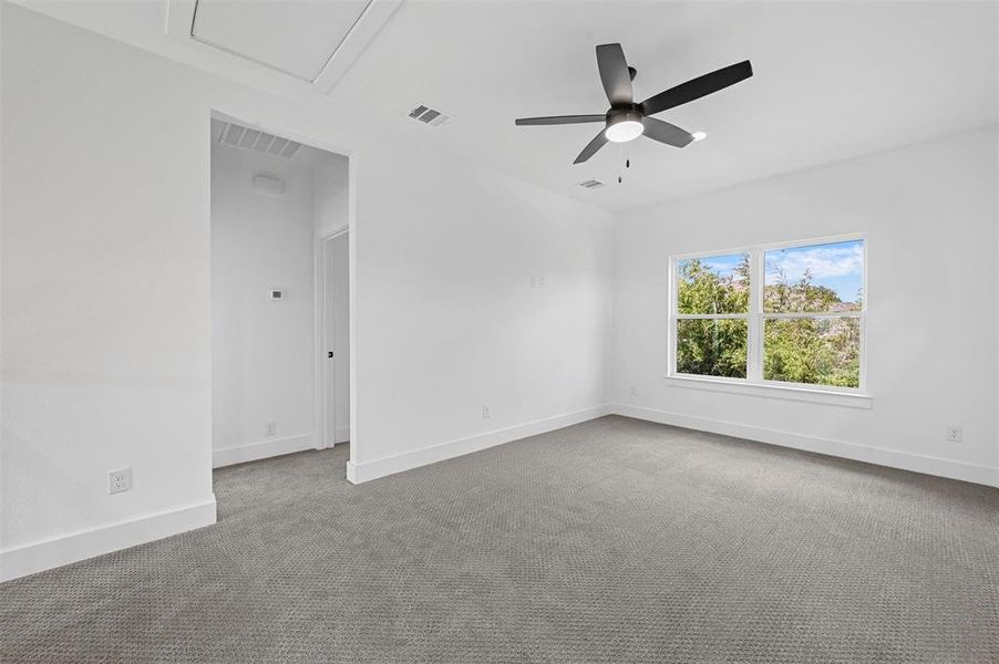 Spare room featuring ceiling fan and carpet