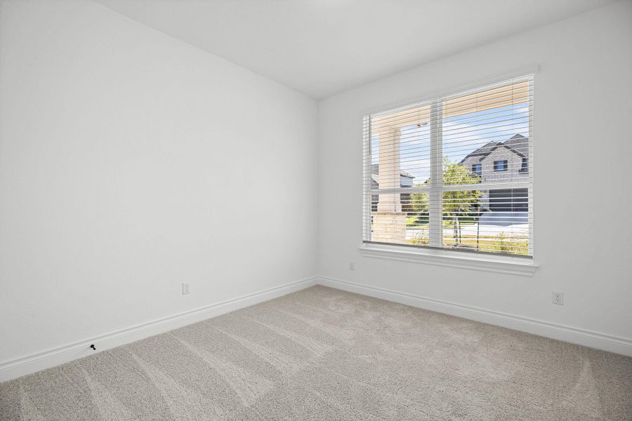 Carpeted empty room featuring baseboards