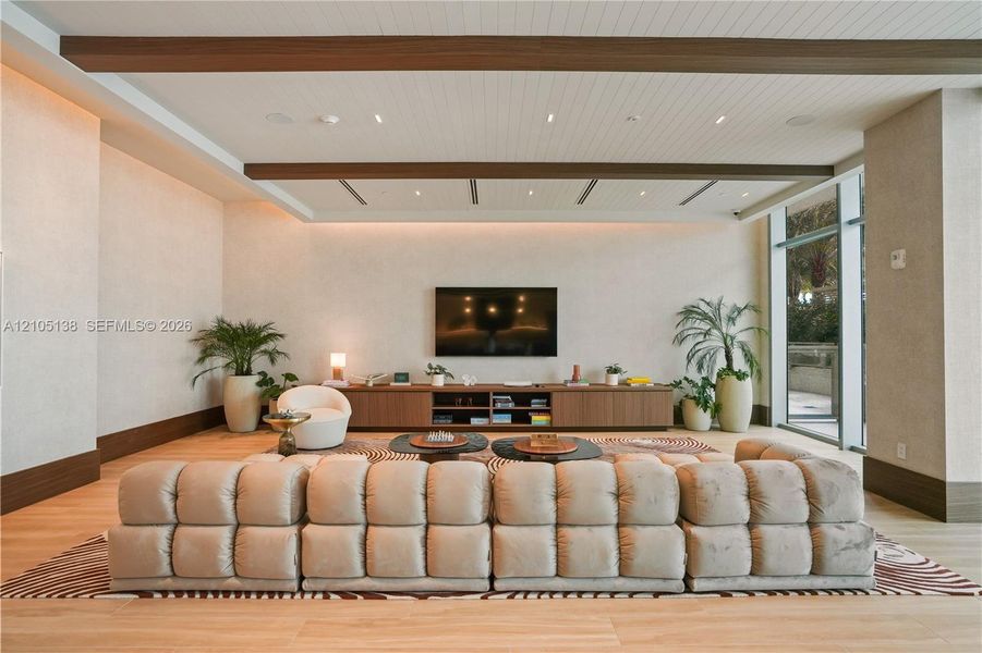 Wood-finish flooring, accent wall, built-in media console, recessed lighting, floor-to-ceiling window