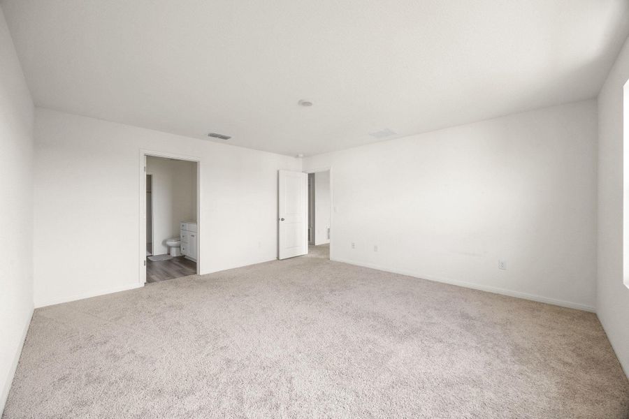 Spare room featuring light colored carpet