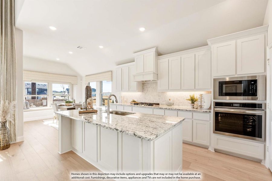 Kitchen with white cabinets, granite island, stainless steel appliances, and light hardwood floors open to dining area. Kitchen with white cabinets, granite island, stainless steel appliances, and light hardwood floors open to dining area.