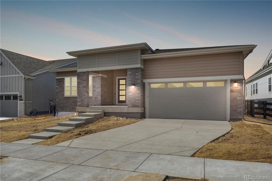 Front exterior of a new home in Retreat at The Canyons, Castle Pines, CO, highlighting curb appeal (Image 1). Front exterior of a new home in Retreat at The Canyons, Castle Pines, CO, highlighting curb appeal (Image 1).