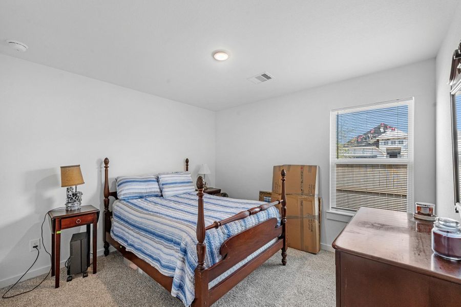 Your secondary bedroom features plush carpet, fresh paint, closet, and a large window that lets in plenty of natural lighting.