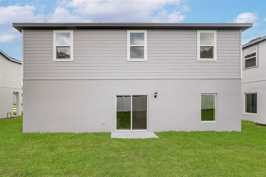 Front exterior of a new home in Tula Parc, Astatula, FL, highlighting curb appeal (Image 2).