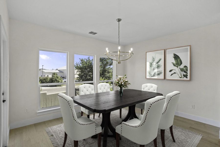 Bright dining space featuring a contemporary chandelier, multiple large windows, and light wood-finish flooring Bright dining space featuring a contemporary chandelier, multiple large windows, and light wood-finish flooring