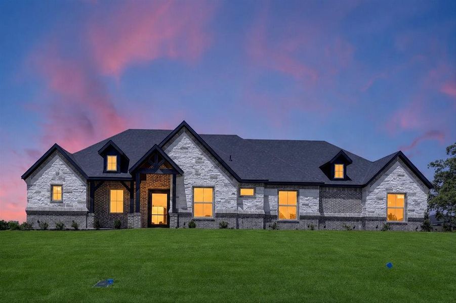 Stone and brick facade with a dark shingle roof