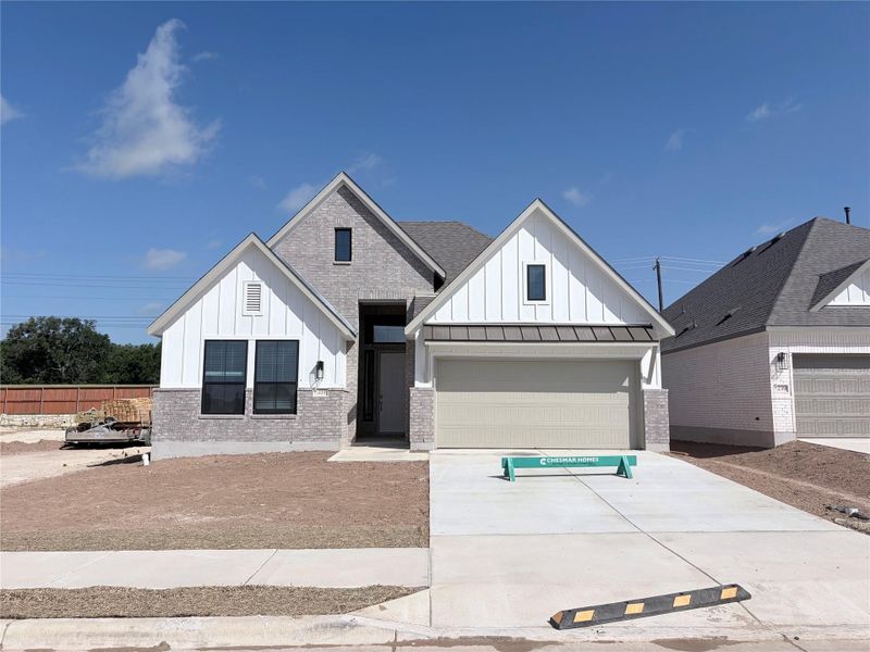 A newly constructed residence showcases a contemporary facade with a two-car garage and a wide driveway. A newly constructed residence showcases a contemporary facade with a two-car garage and a wide driveway.