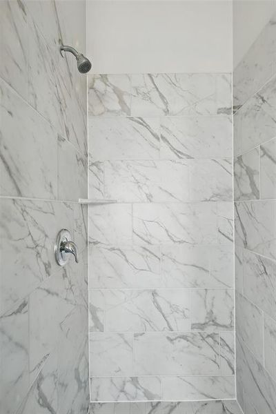 Full bath featuring tiled shower Full bath featuring tiled shower