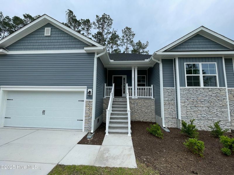 Front exterior of a new home in Mill Creek Cove, Bolivia, NC, highlighting curb appeal (Image 10).