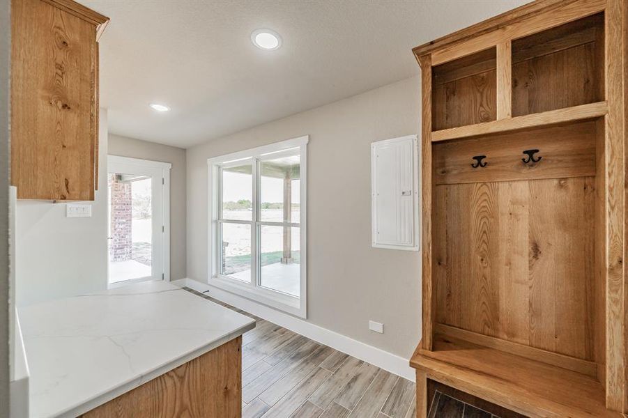 Mudroom with light wood finished floors, electric panel, and recessed lighting Mudroom with light wood finished floors, electric panel, and recessed lighting