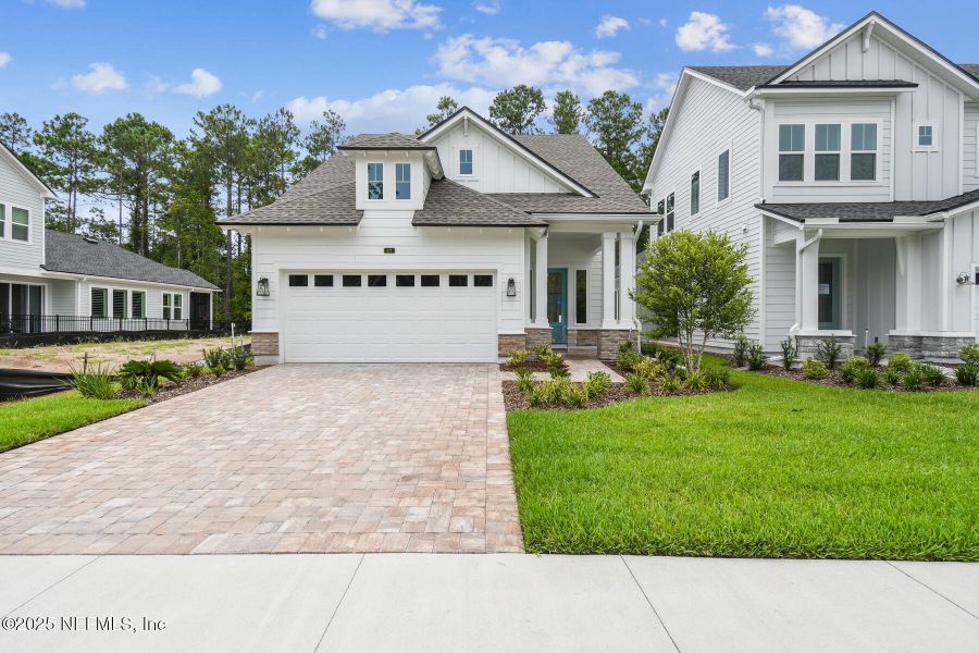 Front exterior of a new home in Reflections 40' Front Load, Ponte Vedra, FL, highlighting curb appeal (Image 1).
