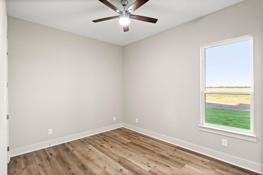 Spare room with light wood-style floors and ceiling fan Spare room with light wood-style floors and ceiling fan