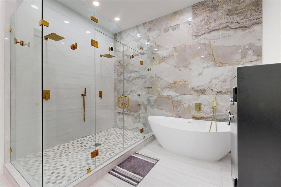 Full bathroom with a soaking tub, tile walls, a stall shower, and recessed lighting Full bathroom with a soaking tub, tile walls, a stall shower, and recessed lighting