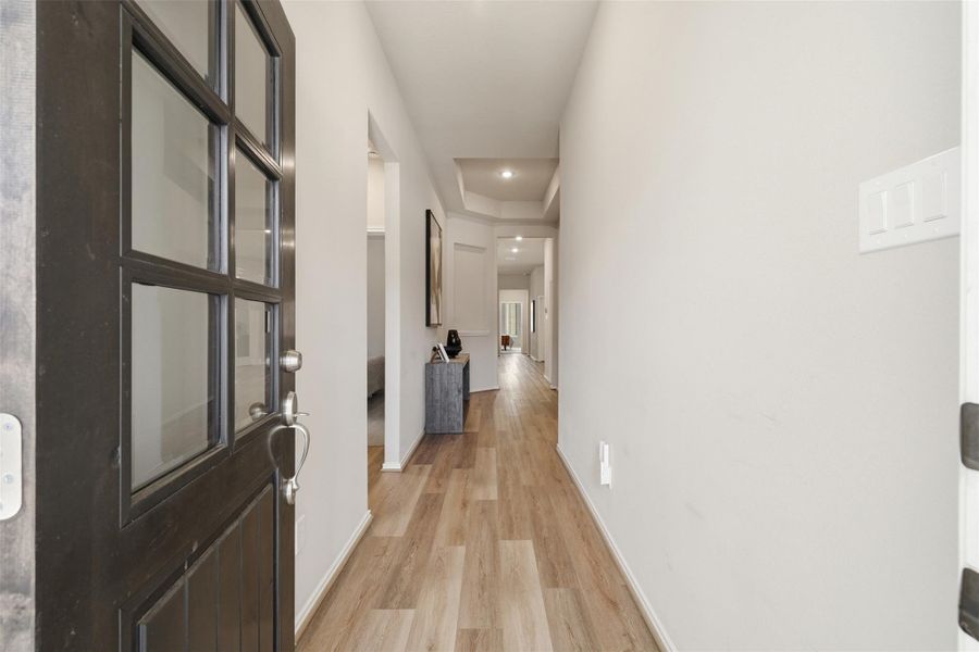 Welcome to a bright, inviting entryway with sleek wood flooring and modern finishes, leading to a spacious, open interior Welcome to a bright, inviting entryway with sleek wood flooring and modern finishes, leading to a spacious, open interior