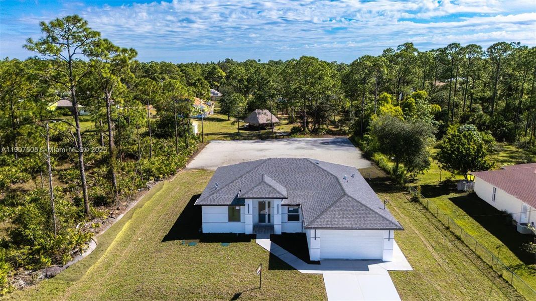 Front exterior of a new home in , Lehigh Acres, FL, highlighting curb appeal (Image 14).