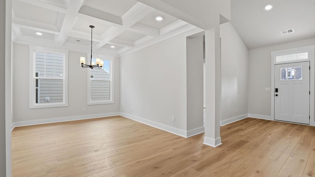 Thoughtful design meets architectural elegance in this coffered ceiling dining room near Greenville