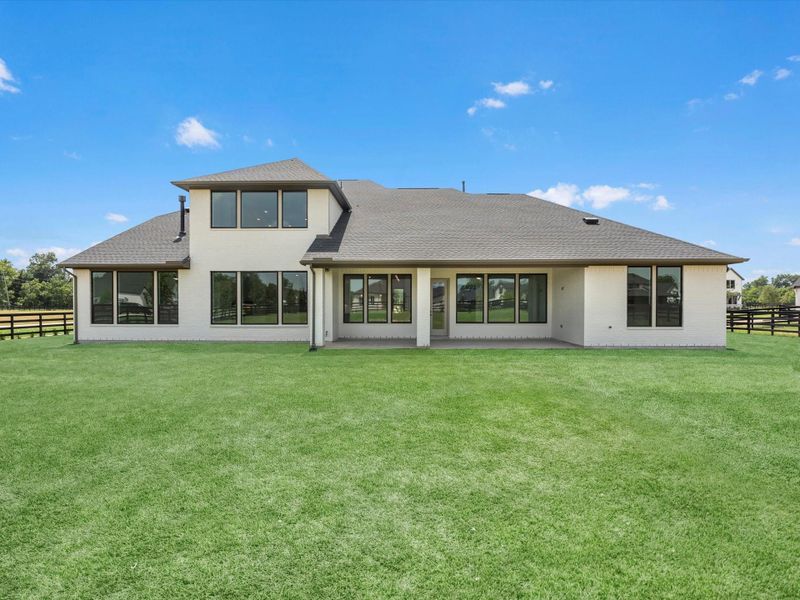 Front exterior of a new home in The Estates at James Lane, Fulshear, TX, highlighting curb appeal (Image 17). Front exterior of a new home in The Estates at James Lane, Fulshear, TX, highlighting curb appeal (Image 17).