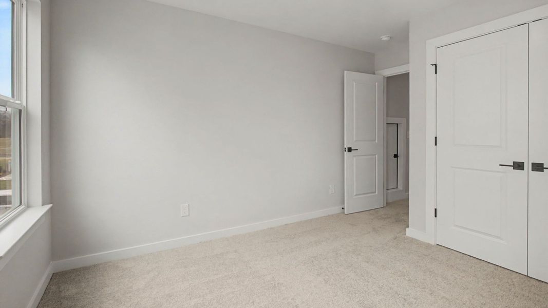 Second floor bedroom with closet and storage area