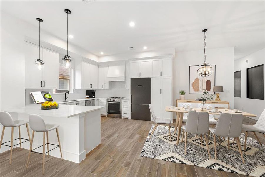 A stunning white kitchen showcasing custom solid wood cabinets and a spacious island offering additional seating. The adjacent dining area seamlessly connects to this custom kitchen, making it ideal for entertaining or family meals. (Virtually staged)