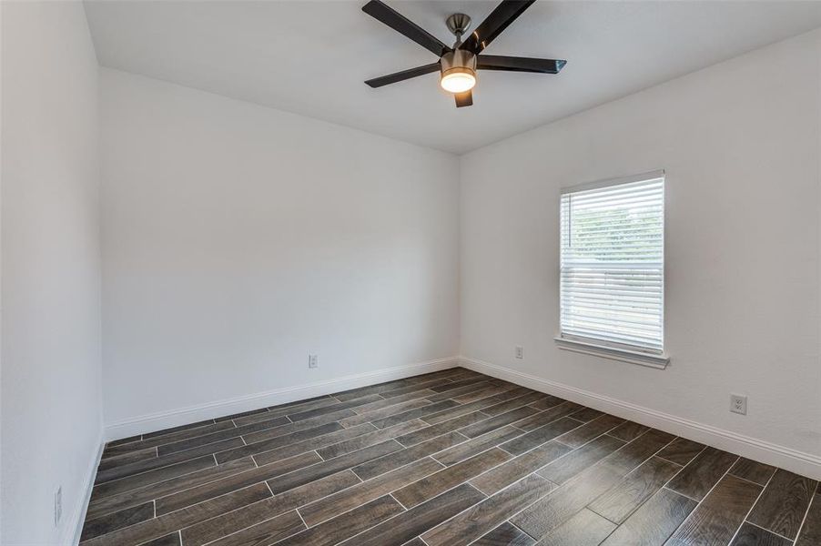 Spare room featuring wood finish floors and a ceiling fan Spare room featuring wood finish floors and a ceiling fan