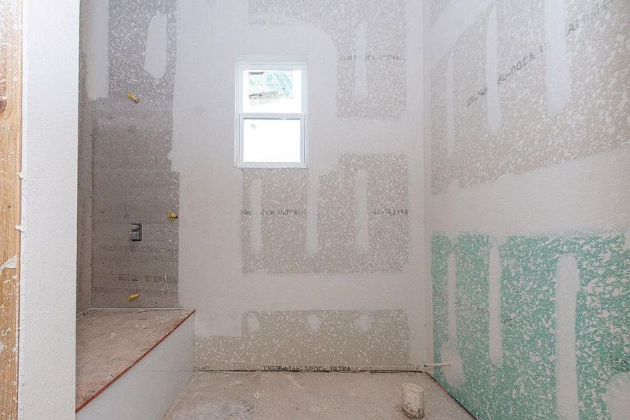 Spacious under-construction bathroom featuring a single window, ready for your custom finishes and fixtures. Spacious under-construction bathroom featuring a single window, ready for your custom finishes and fixtures.