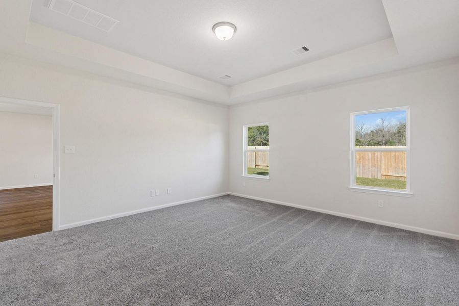 The Crawford- Primary Suite with Tray Ceiling. Sample image for illustration; upgrades, options, and colors may vary. The Crawford- Primary Suite with Tray Ceiling. Sample image for illustration; upgrades, options, and colors may vary.