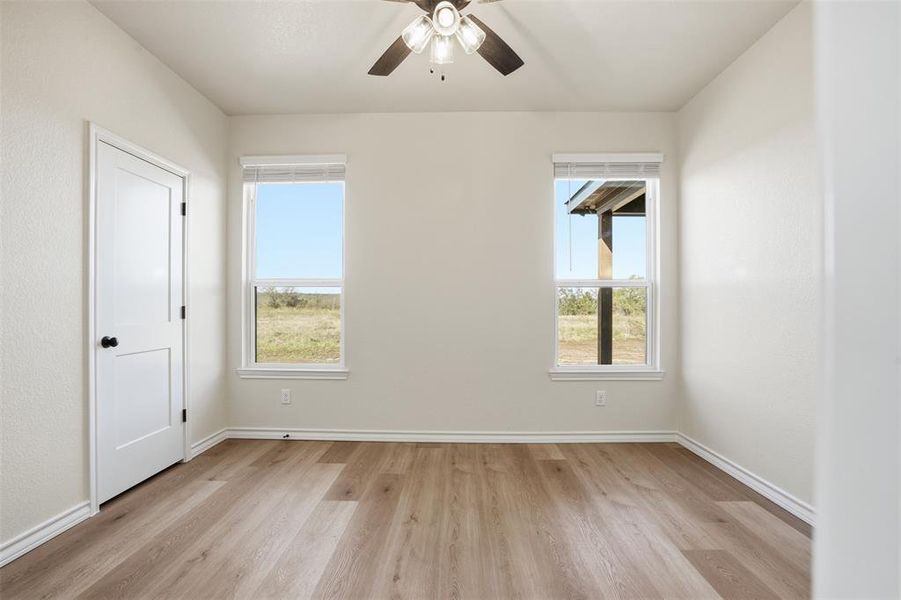 Spare room with light wood-style flooring and ceiling fan Spare room with light wood-style flooring and ceiling fan