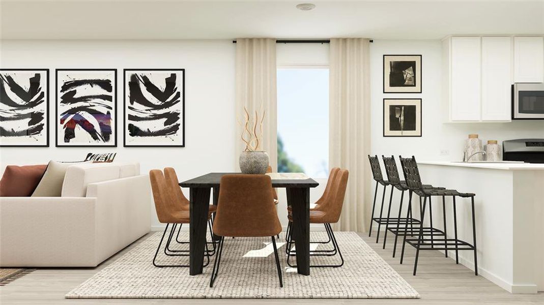 Dining space with light hardwood / wood-style flooring