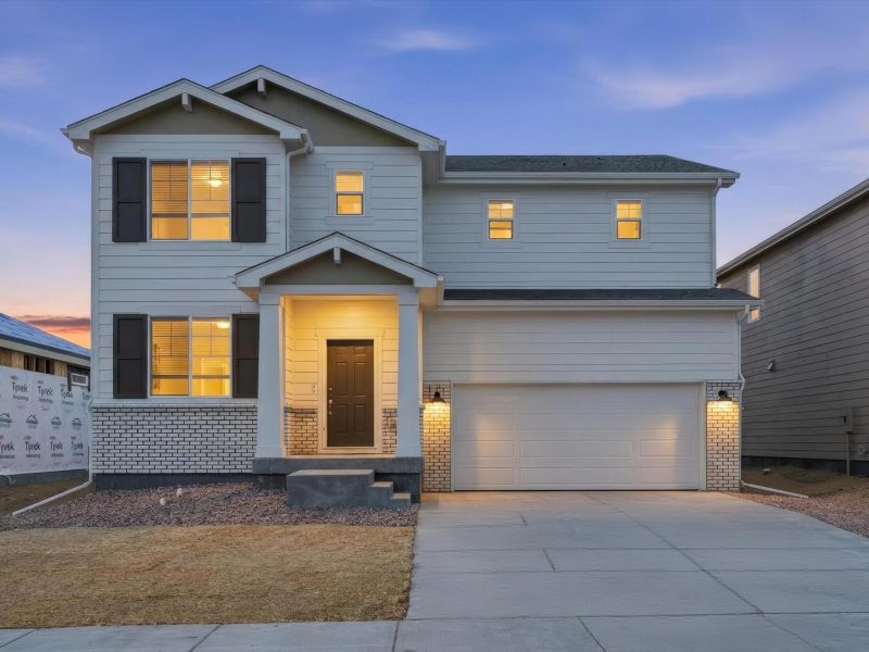 Front exterior of a new home in Meridian Ranch, Peyton, CO, highlighting curb appeal (Image 1). Front exterior of a new home in Meridian Ranch, Peyton, CO, highlighting curb appeal (Image 1).