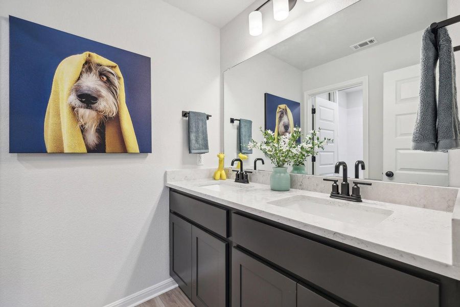 Dual vanity with sleek fixtures offers ample space and a stylish design. Dual vanity with sleek fixtures offers ample space and a stylish design.