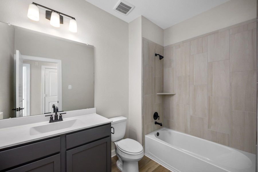 The secondary bathroom is fitted with beautiful tiles and upgraded fixtures.