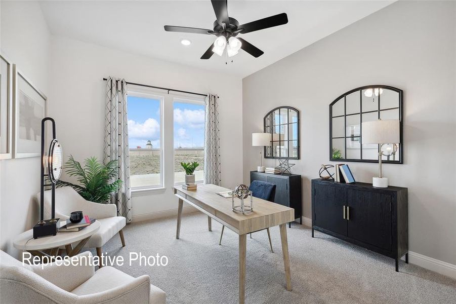 Spacious room featuring vaulted ceilings, a prominent ceiling fan with integrated lighting, and carpeted flooring