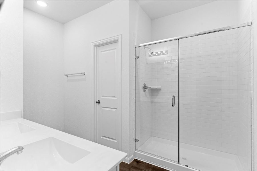 Large walk-in shower offers a clean, modern design, completing the spa-style primary bath. Large walk-in shower offers a clean, modern design, completing the spa-style primary bath.