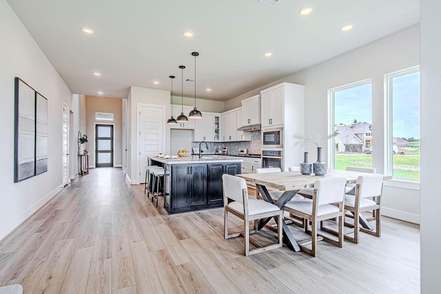 Open-concept design shines in this airy space featuring a gourmet kitchen, dining area, and direct access to the backyard.