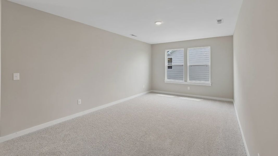 Second Floor Loft area with windows and carpet Second Floor Loft area with windows and carpet
