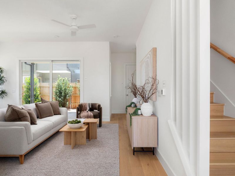 Natural light floods this living area, offering a seamless transition to the outdoors through sliding glass doors.