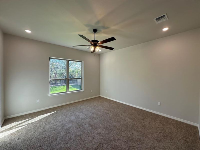 Empty room with recessed lighting, dark carpet, and ceiling fan Empty room with recessed lighting, dark carpet, and ceiling fan