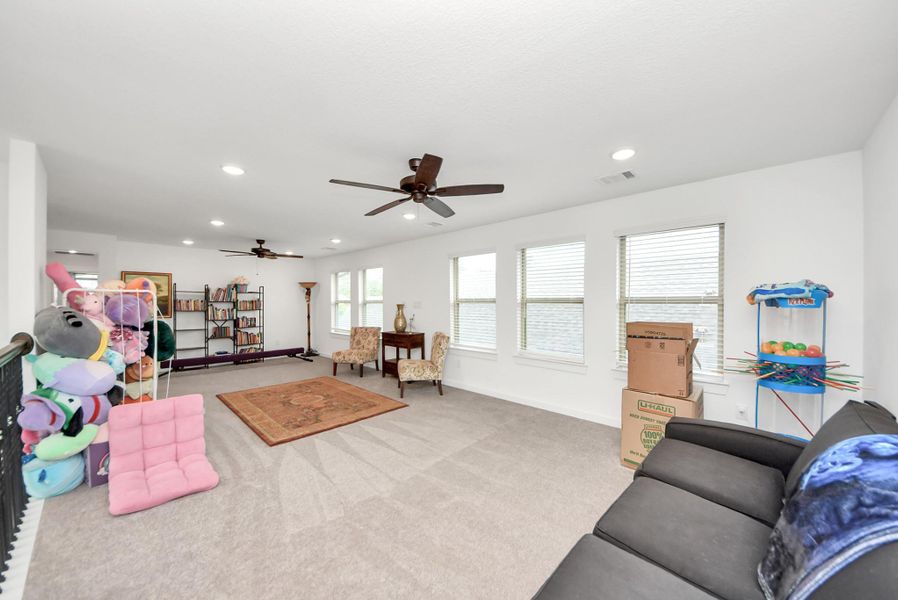 Large upstairs living area perfect for a media room, playroom, or second lounge.