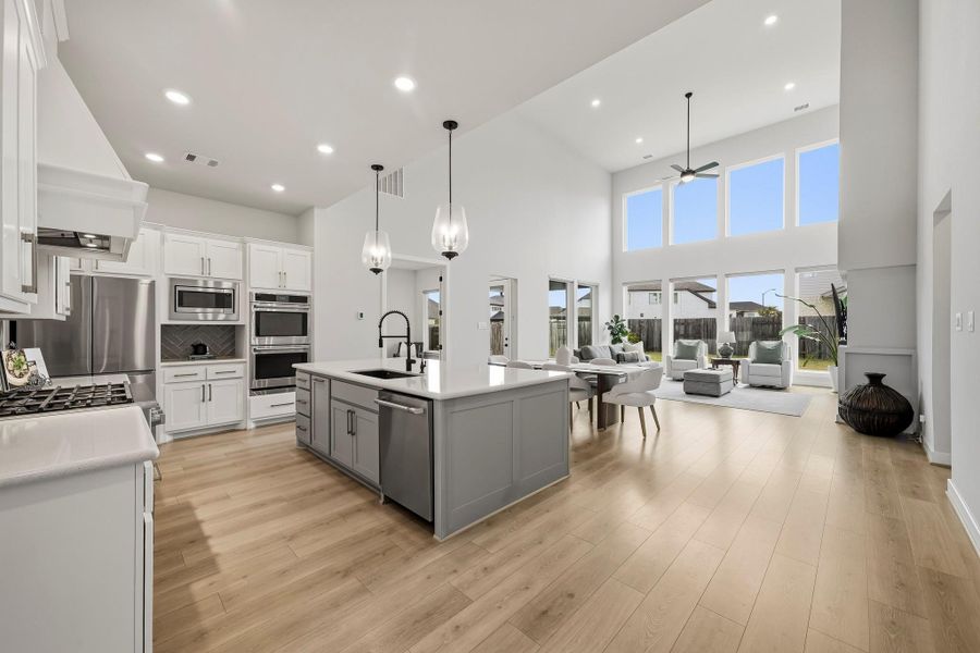 The kitchen, dining and family room flow seamlessly together in a sophisticated open-concept design creating an elegant yet inviting setting for intimate evenings, relaxed everyday living and beautiful gatherings.