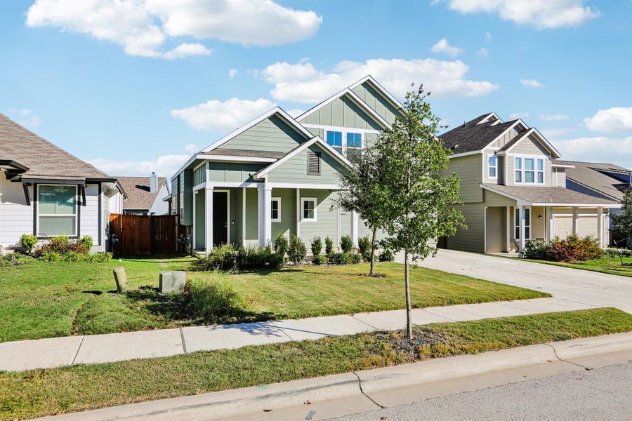 Front exterior of a new home in Orchard Ridge, Liberty Hill, TX, highlighting curb appeal (Image 21).