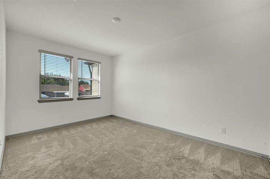 Unfurnished room with carpet floors and baseboards Unfurnished room with carpet floors and baseboards