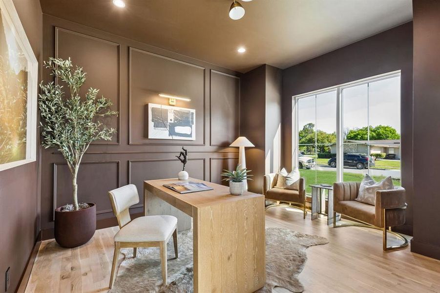 Office area with a decorative wall, light wood-type flooring, and recessed lighting