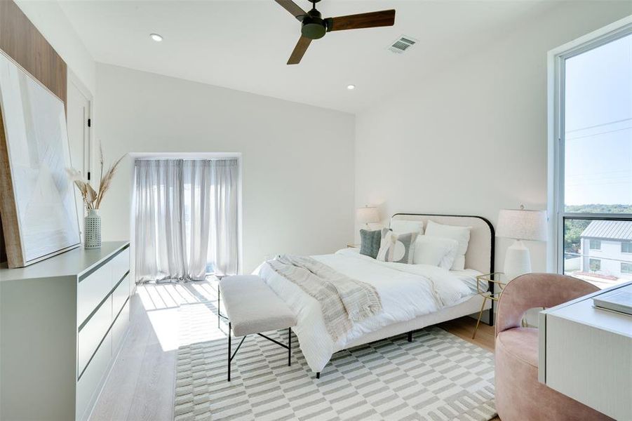 Bedroom featuring light hardwood / wood-style floors and ceiling fan