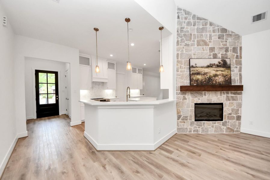 View from living room to front entry and kitchen.