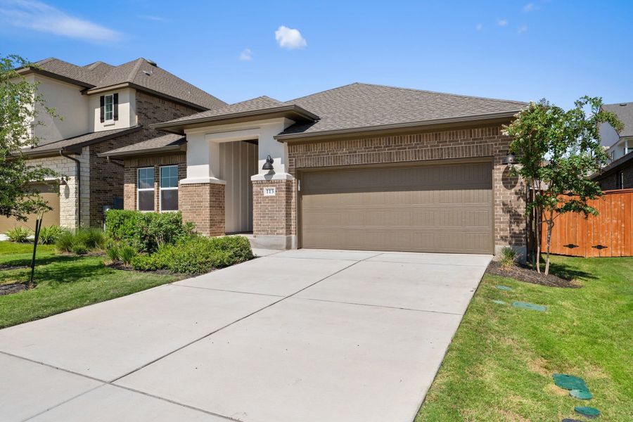 Front exterior of a new home in Lariat, Liberty Hill, TX, highlighting curb appeal (Image 28).