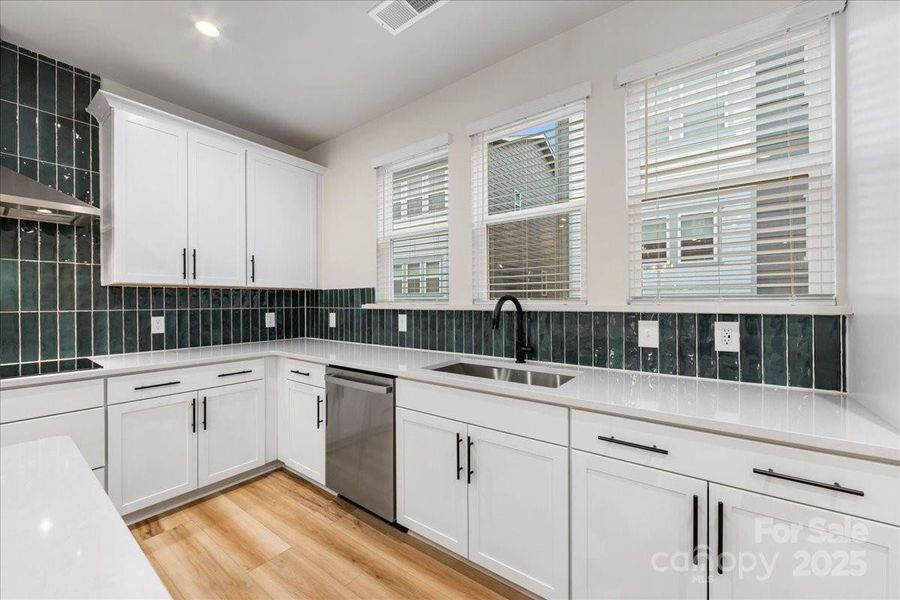 Large Windows Above Sink with Included Window Treatments.