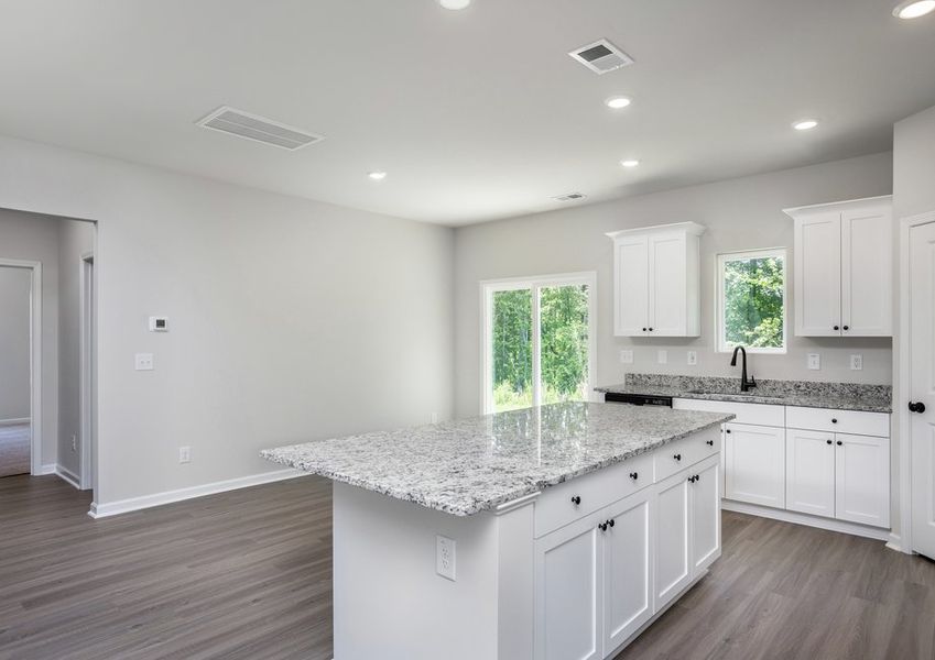 The kitchen opens to the family room and dining room. The kitchen opens to the family room and dining room.
