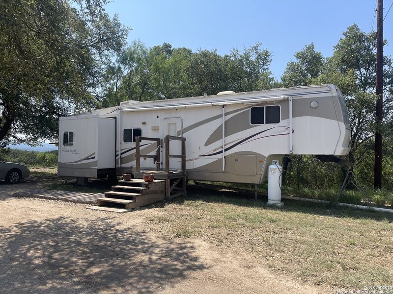 Front exterior of a new home in , Bandera, TX, highlighting curb appeal (Image 26).