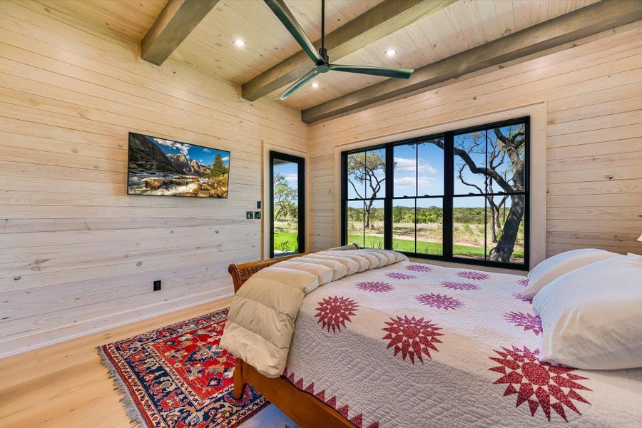 Bedroom with access to outside, wood finished floors, wood walls, ceiling fan, and recessed lighting