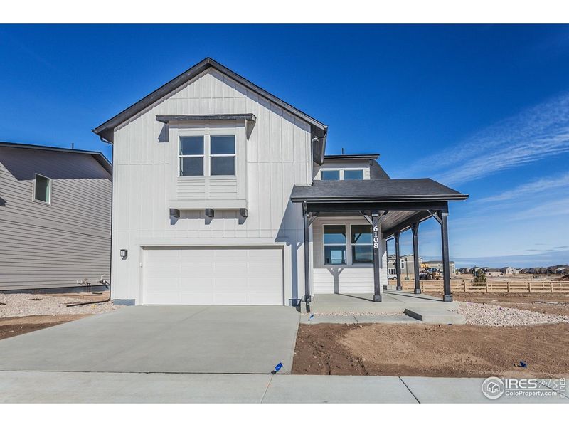 Front exterior of a new home in Trailside Story Collection - Single Family Homes, Timnath, CO, highlighting curb appeal (Image 2). Front exterior of a new home in Trailside Story Collection - Single Family Homes, Timnath, CO, highlighting curb appeal (Image 2).